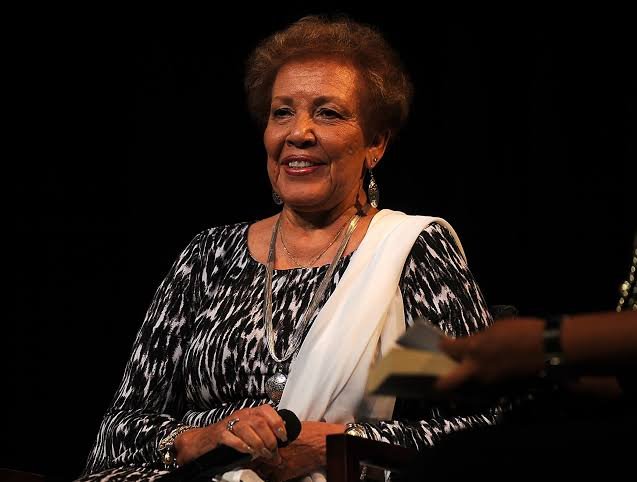 Image Alt Text Joylette Goble, daughter of NASA mathematician Katherine Johnson, with an educational illustration representing her family's scientific legacy.